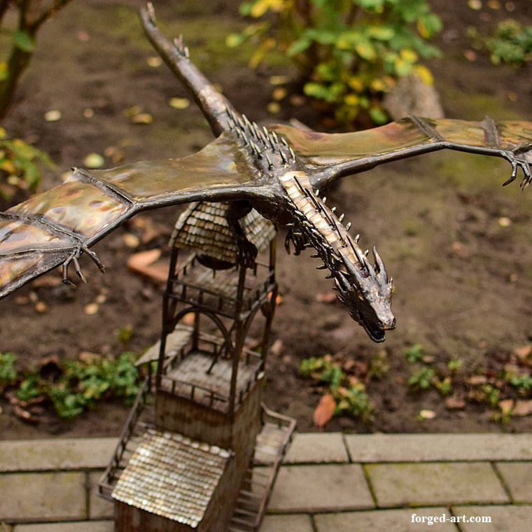 The dragon Smaug on the tower - a forged statue of stainless steel